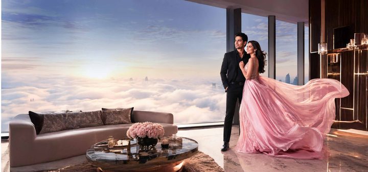 Residents looking out over the clouds through a floor-to-ceiling window, artist's impression